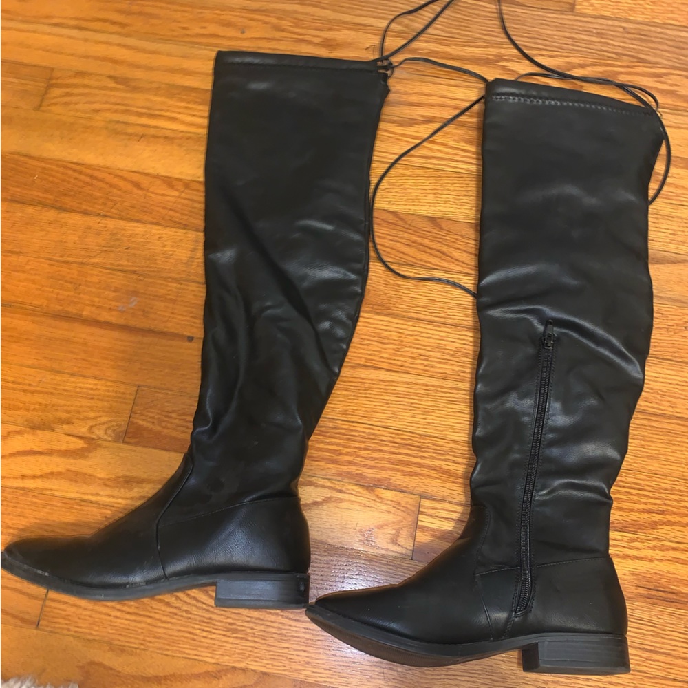 Over the knee black boots.